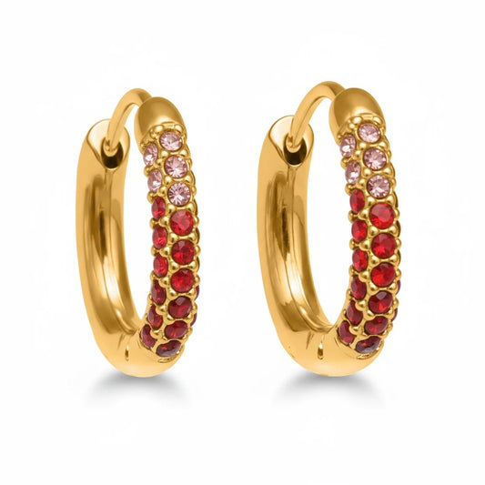 Meinara Circa gold hoop earrings featuring rows of sparkling red and pink crystals in a polished stainless steel finish.