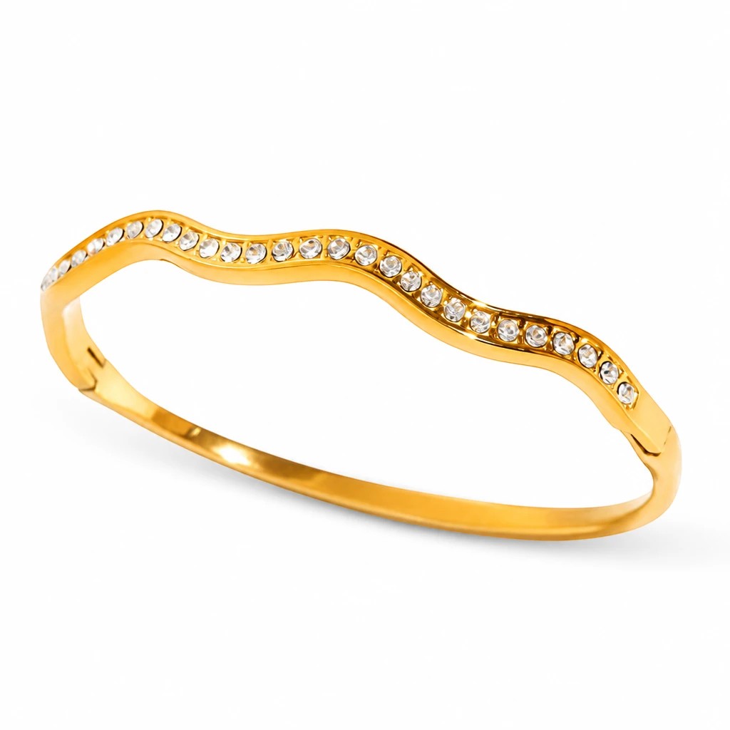 Meinara Elara bangle featuring a wavy gold-tone band encrusted with sparkling clear crystals