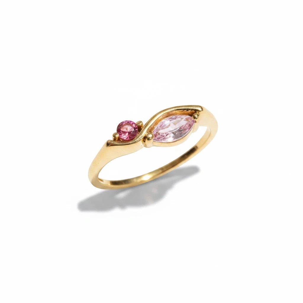 Meinara Freya ring in 18k gold plated stainless steel with a sculptural band and pink marquise-cut stone accents.