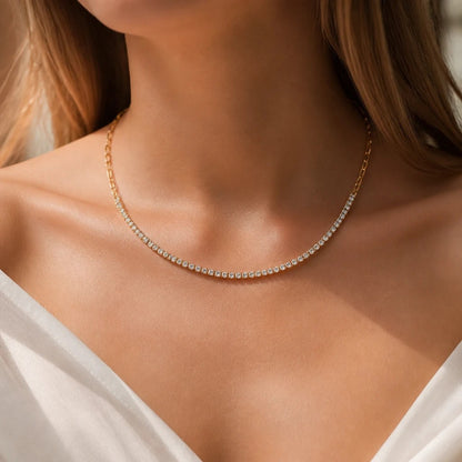 Meinara Lumi necklace featuring a delicate gold chain with a sparkling row of clear crystals on a woman's neck.