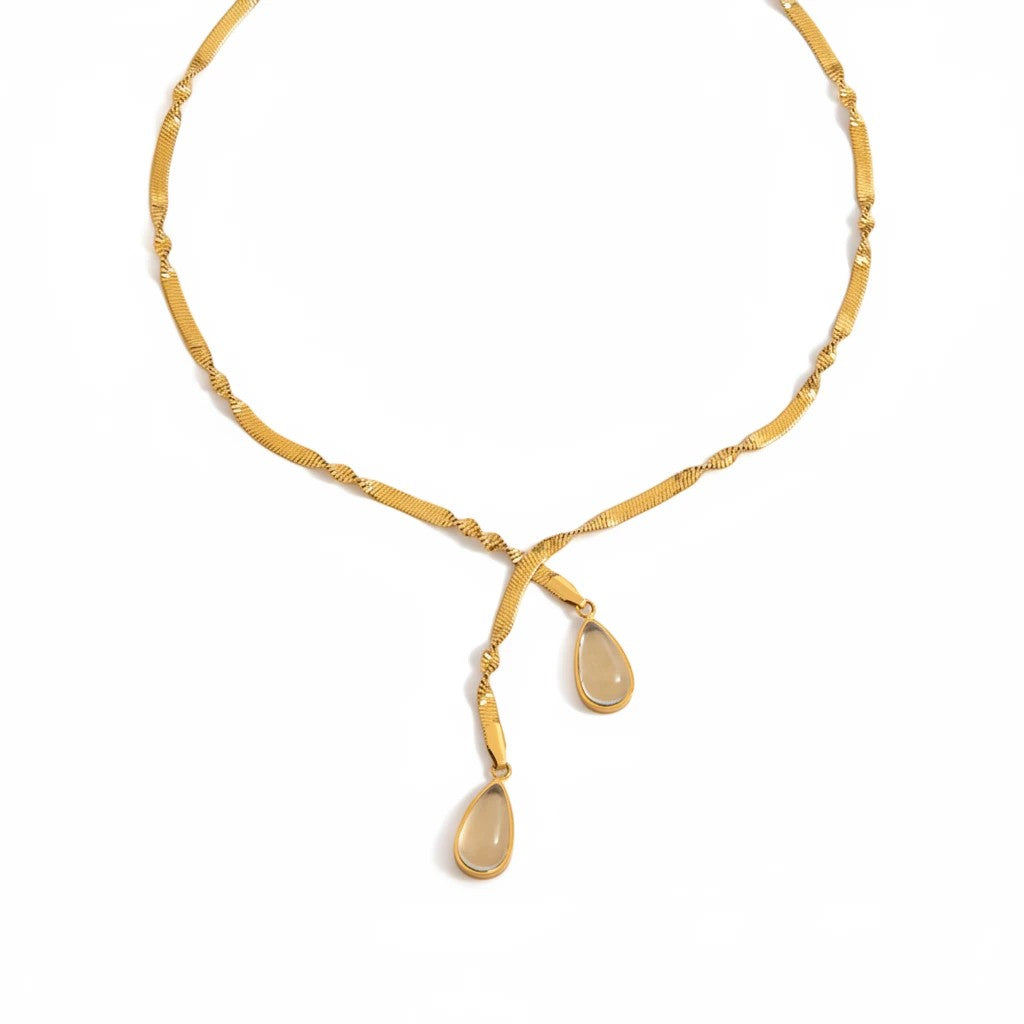 Meinara Lune necklace featuring a gold-toned herringbone chain with two delicate teardrop-shaped stone pendants.