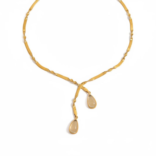 Meinara Lune necklace featuring a gold-toned herringbone chain with two delicate teardrop-shaped stone pendants.