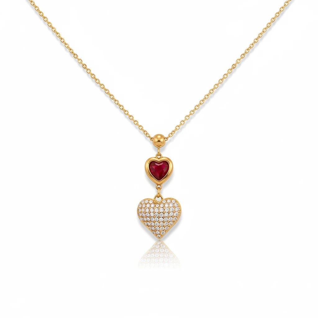 Meinara Mila necklace featuring a gold chain with a red heart pendant and a pavé diamond heart charm