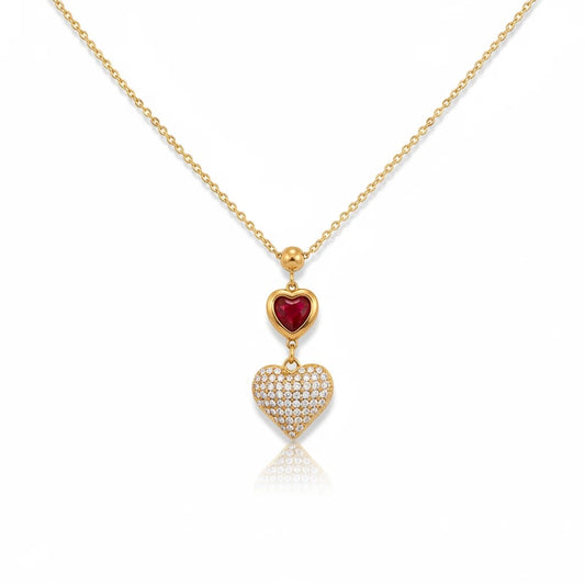 Meinara Mila necklace featuring a gold chain with a red heart pendant and a pavé diamond heart charm