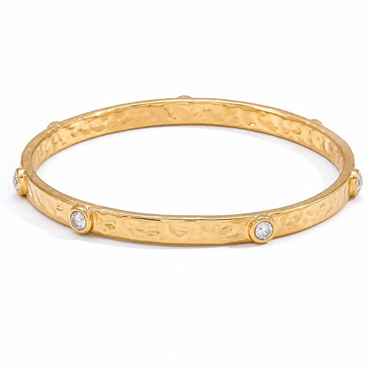 Meinara Nova bangle in gold with a hammered texture and bezel-set round clear crystals.