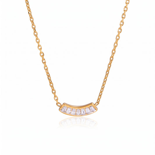 Meinara Siena necklace featuring a curved gold pendant with baguette-cut crystals on a delicate chain